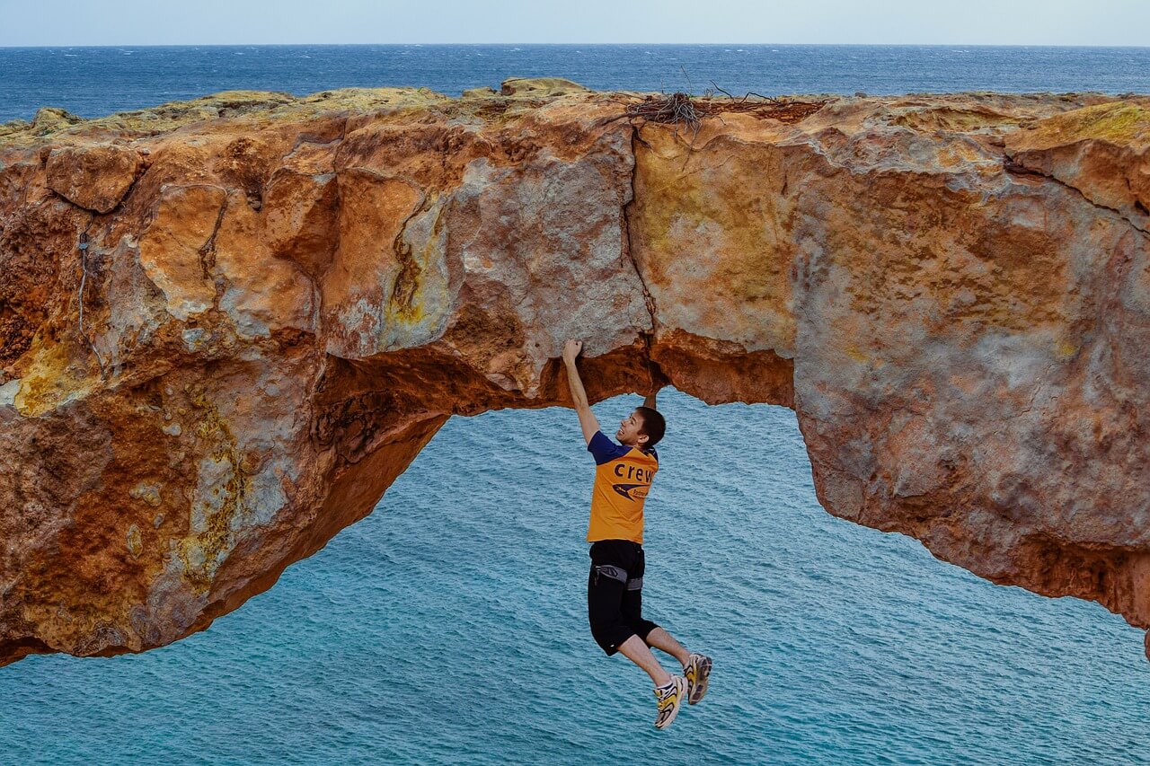 Free soloing climbing in natural arch